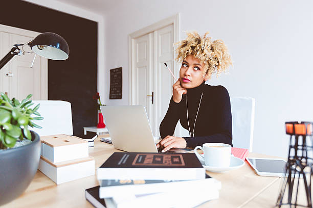 istock Afro american young woman in a home office 599676132