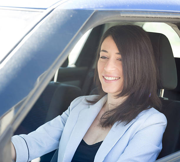 istock Happy woman driving her car 599676406