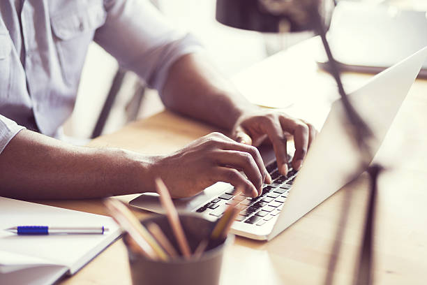 istock Afro american young man typing on laptop 599676702
