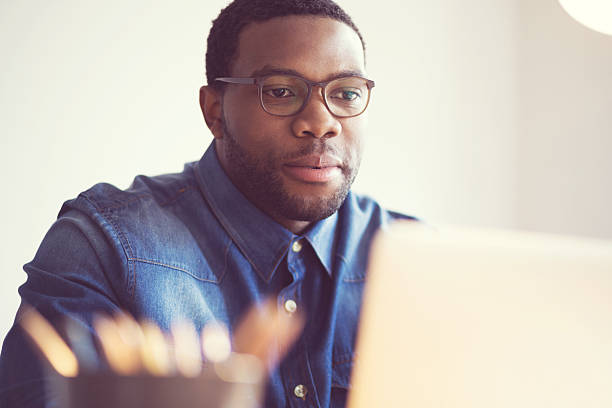 istock Afro american young man in a home office 599676800