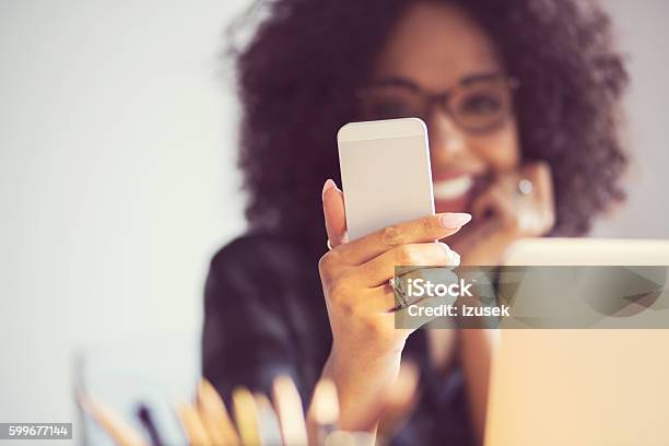 Beautiful Woman Using Smart Phone At Home Stock Photo - Download Image Now - Adult, Adults Only, African Ethnicity