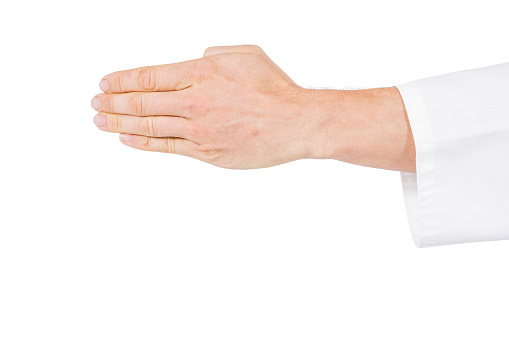 Close-up of karate player making hand gesture on white background