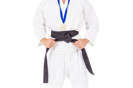 Fighter posing with medal around his neck on white background
