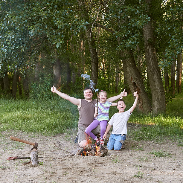 istock people camping in forest, family active in nature, kindle fire 599678238