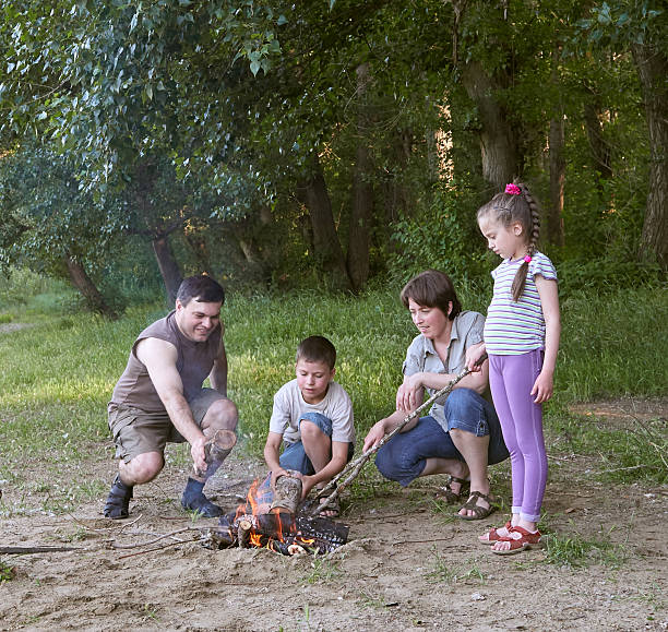 istock people camping in forest, family active in nature, kindle fire 599678574