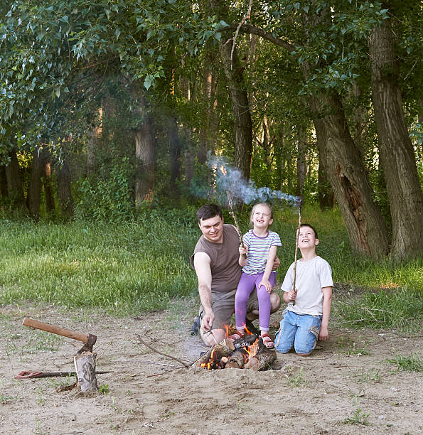 istock people camping in forest, family active in nature, kindle fire 599678666