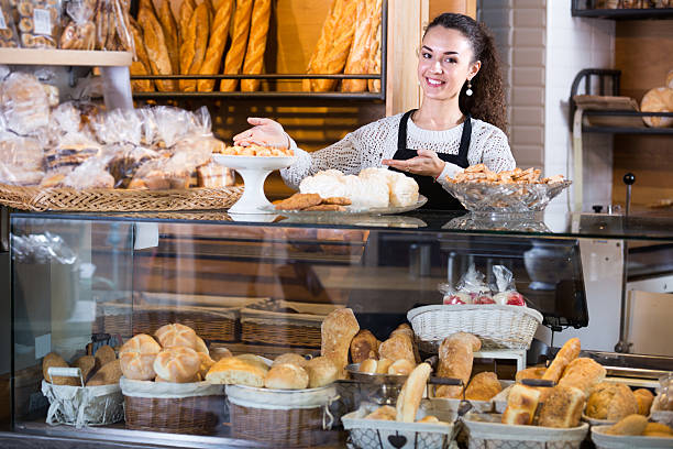 istock young woman at bakery display 599682710