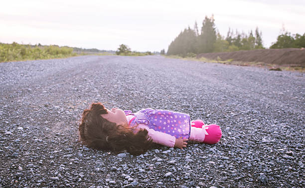istock Concept Abandoned Person,Abandoned doll laying on road 599683060