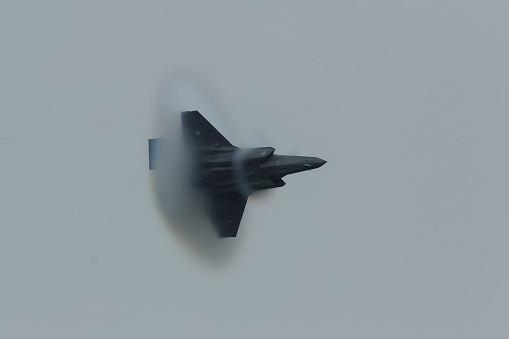 Leeuwarden, Netherlands june 11, 2016: Duing an air strike demo at the Luchtmachtdagen airshow, an F-35 approaches the sound barrier.