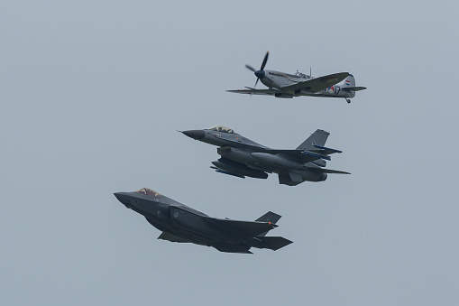 Leeuwarden, Netherlands June 11, 2016: A Lockheed Martin F-35 Lighting II, A F-16 Fighting Falcon and a Supermarine Spitfire of the RNLAF are flying in formation during the Luchtmachtdagen Airshow
