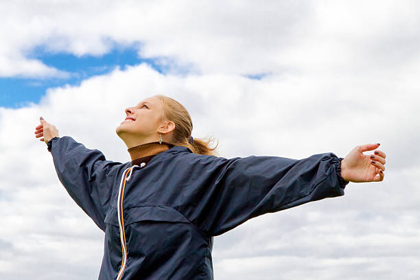 istock Happy woman with raised arms 599683678