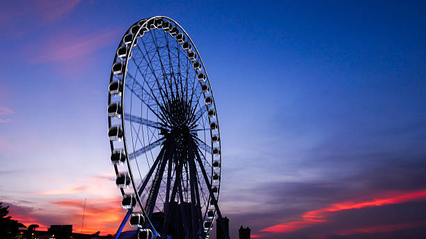 istock Ferris wheel in motion at sunset time 599684864