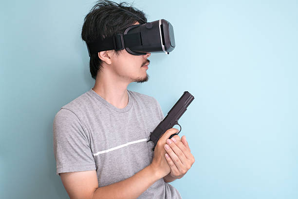 istock Man with a head mounted display holding a gun 599685136