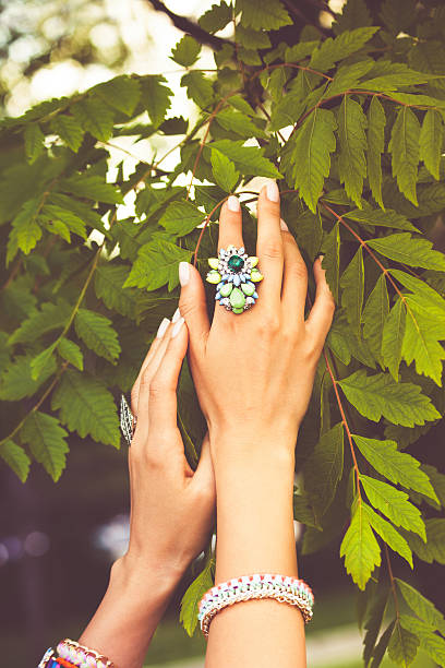 istock female hands with rings on leaves 599688602