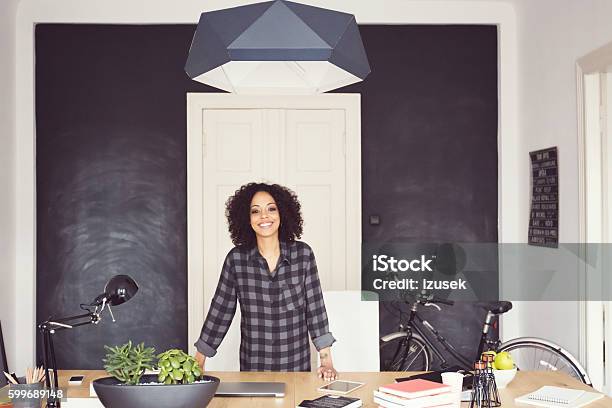 Afro American Young Woman In An Office Stock Photo - Download Image Now - African Ethnicity, Desk, Ecstatic