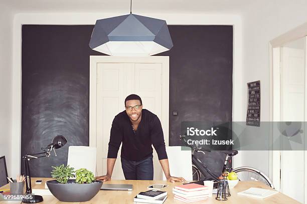 Afro American Young Man In An Office Stock Photo - Download Image Now - Owner, African Ethnicity, Men