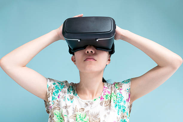 istock Woman with a head mounted display 599693430