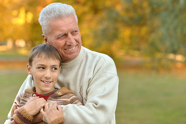 istock Grandfather and grandson in park 599694462