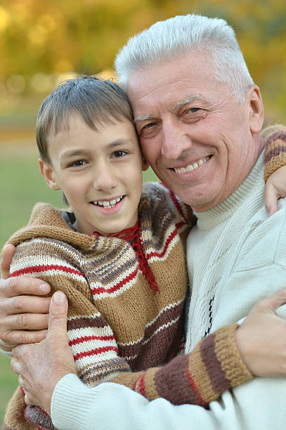 istock Grandfather and grandson in park 599694878