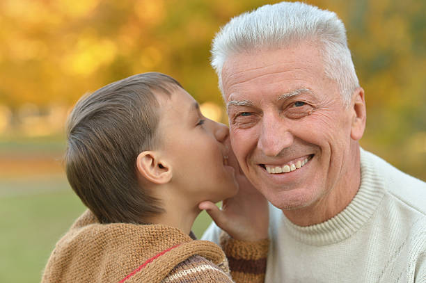 istock Grandfather and grandson in park 599695122