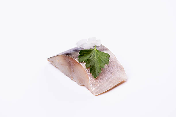istock piece of fish on a white background, studio, isolated, herbs 599703296
