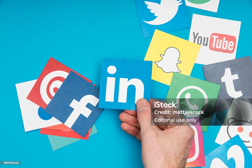 Social media London, United Kingdom - September 6, 2016: A male hand interacting with a collection of popular social media logos. Social Media Stock Photo