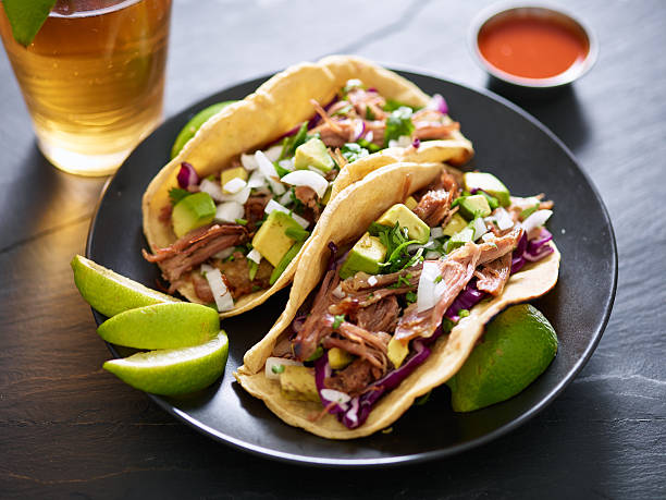 istock pork carnita tacos close up with lime wedges 599704456