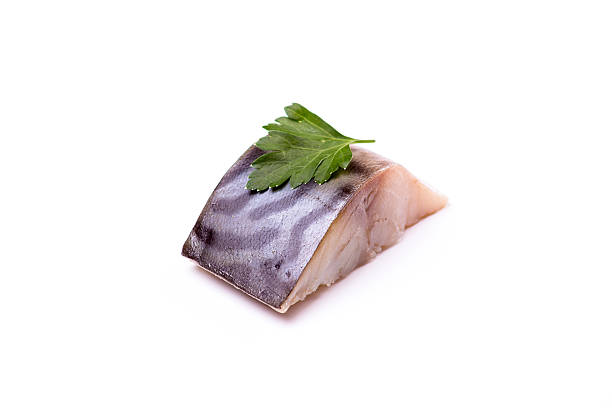 istock piece of fish on a white background, studio, isolated, herbs 599704868