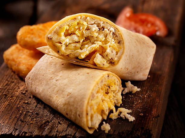 scrambled egg and cheese breakfast wrap - prepared potato food studio shot selective focus imagens e fotografias de stock