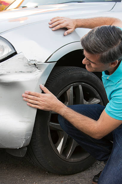 istock Unhappy Driver Inspecting Damage After Car Accident 599706908