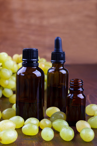 Grape essential oil in small bottle. Beauty treatment