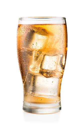 Glass of Guarana soft drink with ice cubes and condensation, isolated on white background with real shadow and clipping path