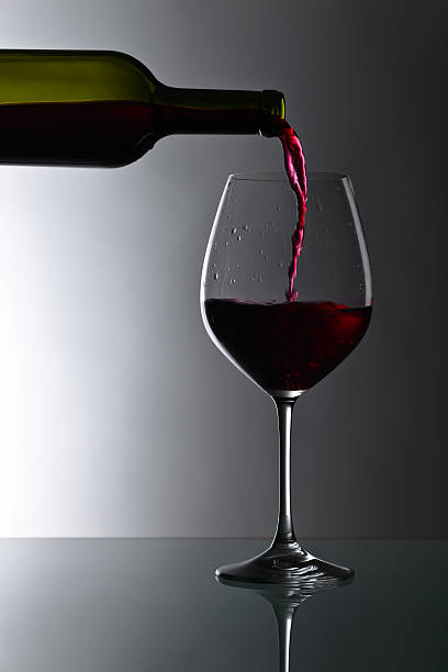 istock bottle and glass of red wine 599707714
