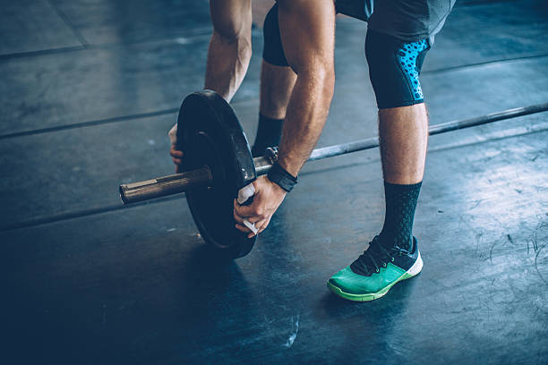 Gym day Young man preparing for exercis deadlift in gym. Professional athletes. Wearing sports clothing. crossfit chalk weightlifting weight training stock pictures, royalty-free photos & images