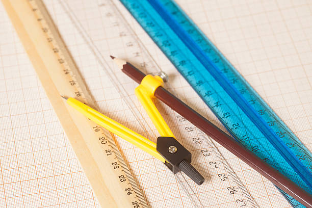 istock Drawing compass with black pensil and rulers on graph paper. 599709310