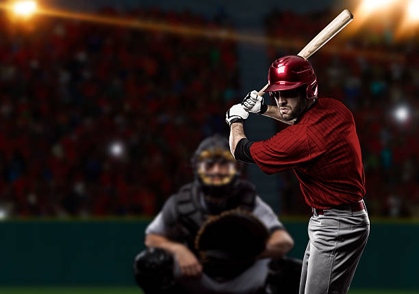 Baseball Player Baseball Player with a red uniform on baseball Stadium. home run photos stock pictures, royalty-free photos & images