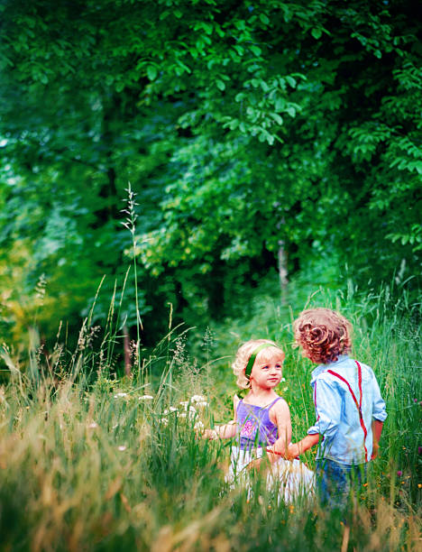 Two kids enjoying outdoor in the forest