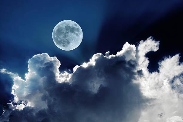 istock Full moon in night sky with clouds glowing in moonlight 599711038