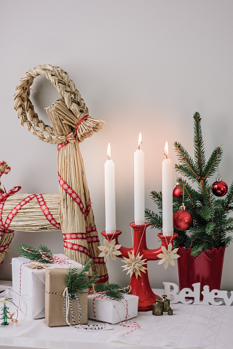 Christmas decorations and wrapped gifts in candle light