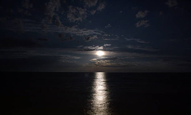 istock Night landscape of the sea, moonlit path 599712328