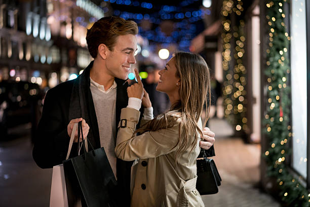 istock Playful couple Christmas shopping 599712356