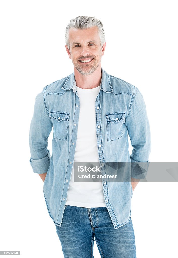 Handsome adult man Portrait of a handsome adult man with grey hair dressed in denim and looking at the camera smiling - isolated over white Men Stock Photo