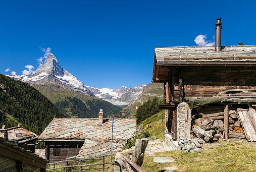 A traditional village in Canton Valais with the famous Matterhorn peak in the background near Zermatt in Switzerland.