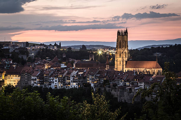 Sunset over Fribourg old town Sunset over Fribourg old town in Switzerland fribourg city switzerland stock pictures, royalty-free photos & images