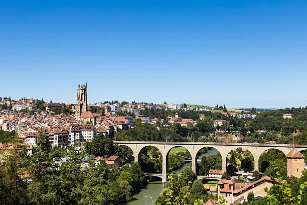 Fribourg skyline A cityscape of Fribourg with its gothic cathedral and medieval fortification in the foreground in Switzerland. fribourg city switzerland stock pictures, royalty-free photos & images
