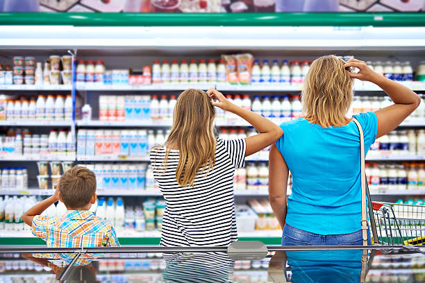 la familia elige los productos lácteos en la tienda - supermarket shopping retail choice fotografías e imágenes de stock