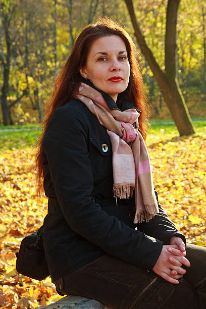 istock Girl on bench in autumn park. 599714812