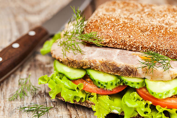 istock Tasty rye bread sandwiches with roast meat and vegetables 599715122