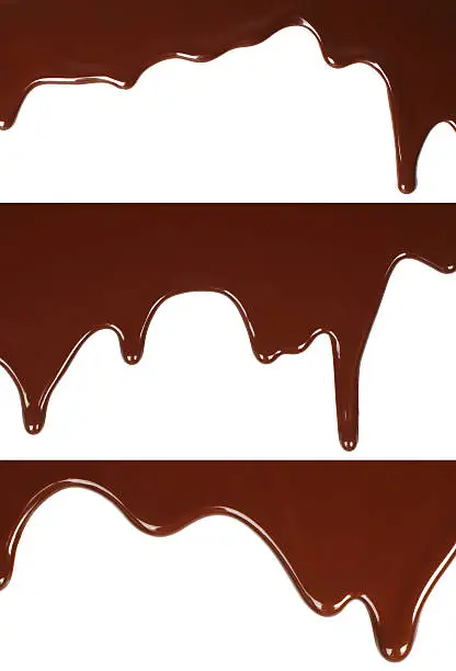 Melted chocolate dripping set on white background close-up
