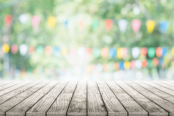istock Empty wooden table with party in garden background blurred. 599716754